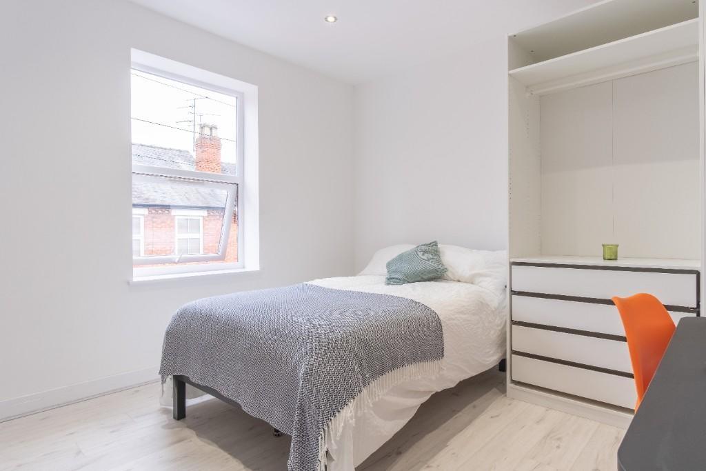 Bright and cozy single bedroom featuring a larg...