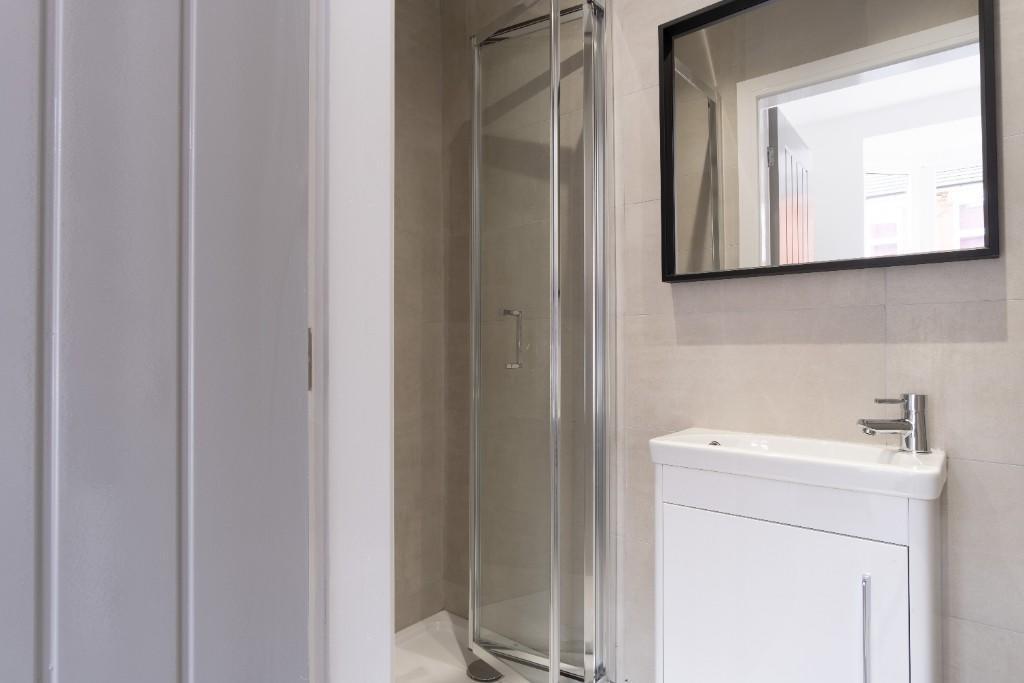 Bright and clean bathroom featuring a modern gl...