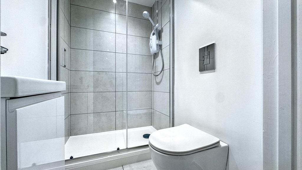 Modern bathroom with a walk-in tiled shower enc...