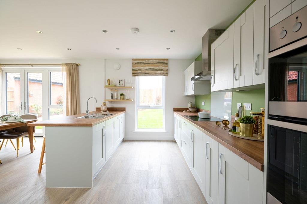 The modern kitchen is light and has ample...