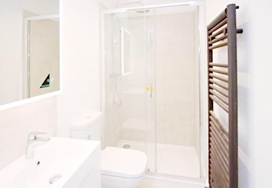 Bright, modern bathroom with a walk-in shower, ...