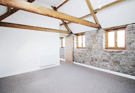 Bright, characterful bedroom with exposed woode...