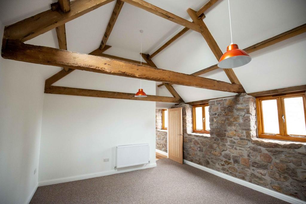 Bright airy bedroom with exposed wooden beams, ...