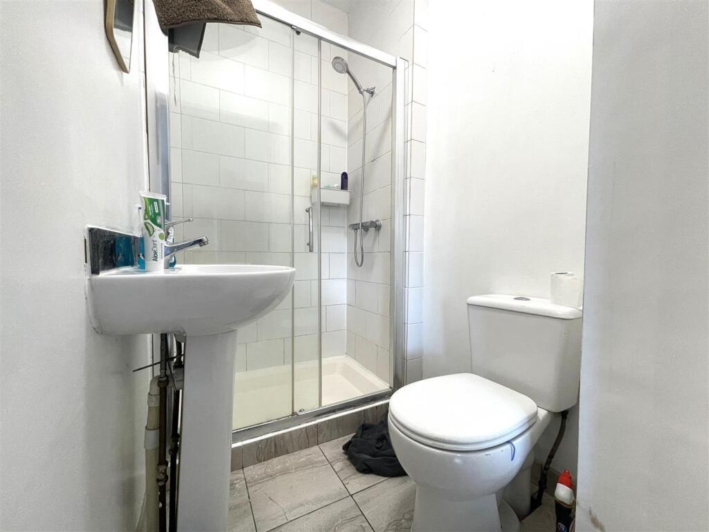 Bright, modern bathroom with a tiled walk-in sh...