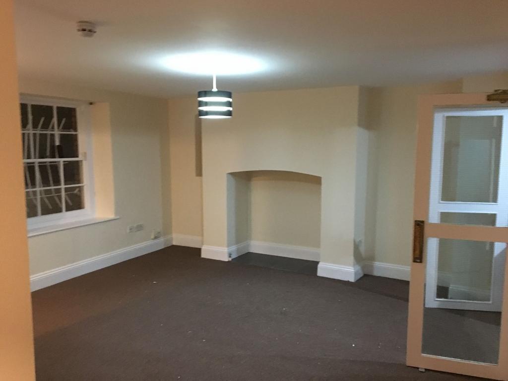 Spacious, neutral-toned living room with a cent...