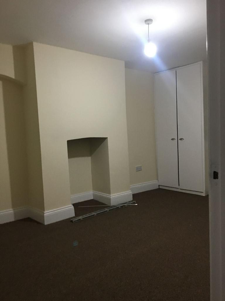 Bright, neutral bedroom with fitted corner ward...