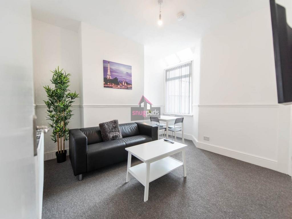 Bright, modern communal living area with a comf...