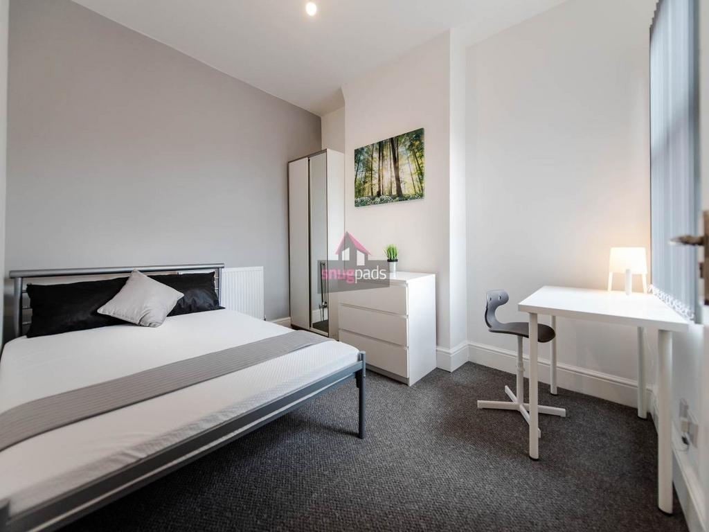 Bright, modern double bedroom with a comfortabl...