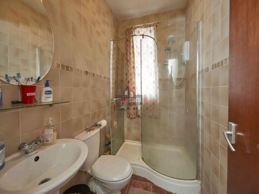 Clean, well-appointed bathroom with a corner sh...