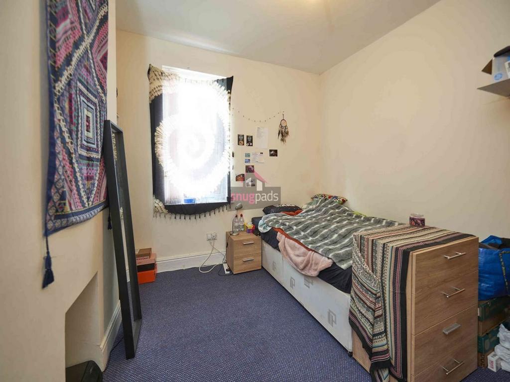 Cozy single bedroom with a neat single bed, bed...