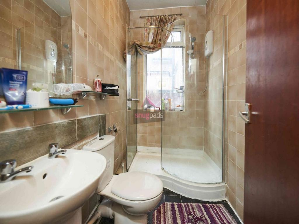 Well-kept bathroom with a modern curved glass s...