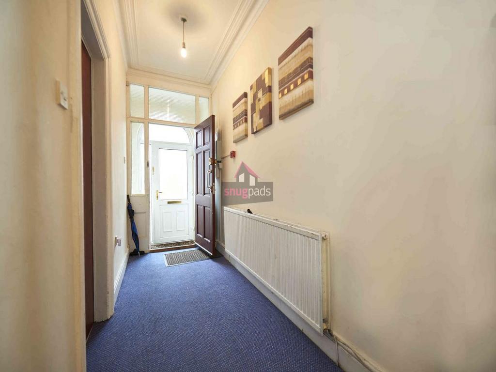 Bright, welcoming hallway with natural light fr...