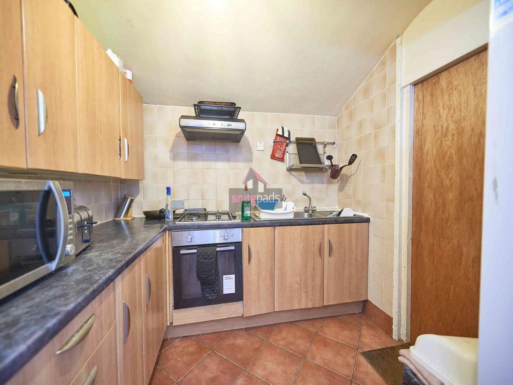 Well-appointed kitchen with wood-effect cabinet...