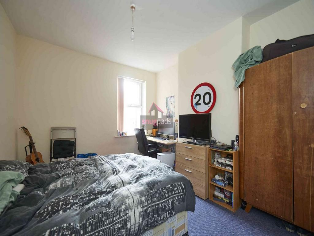 Cozy furnished bedroom with a double bed, wardr...