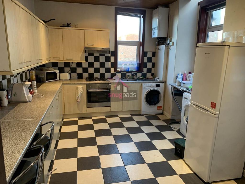 Bright, well-equipped kitchen with modern appli...