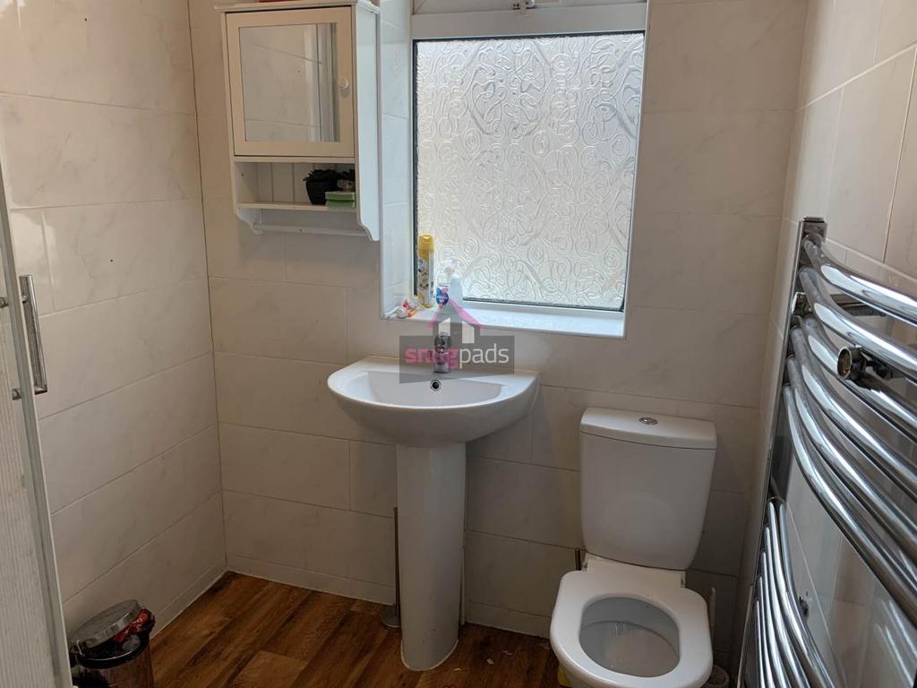 Bright, modern bathroom with a pedestal sink, c...