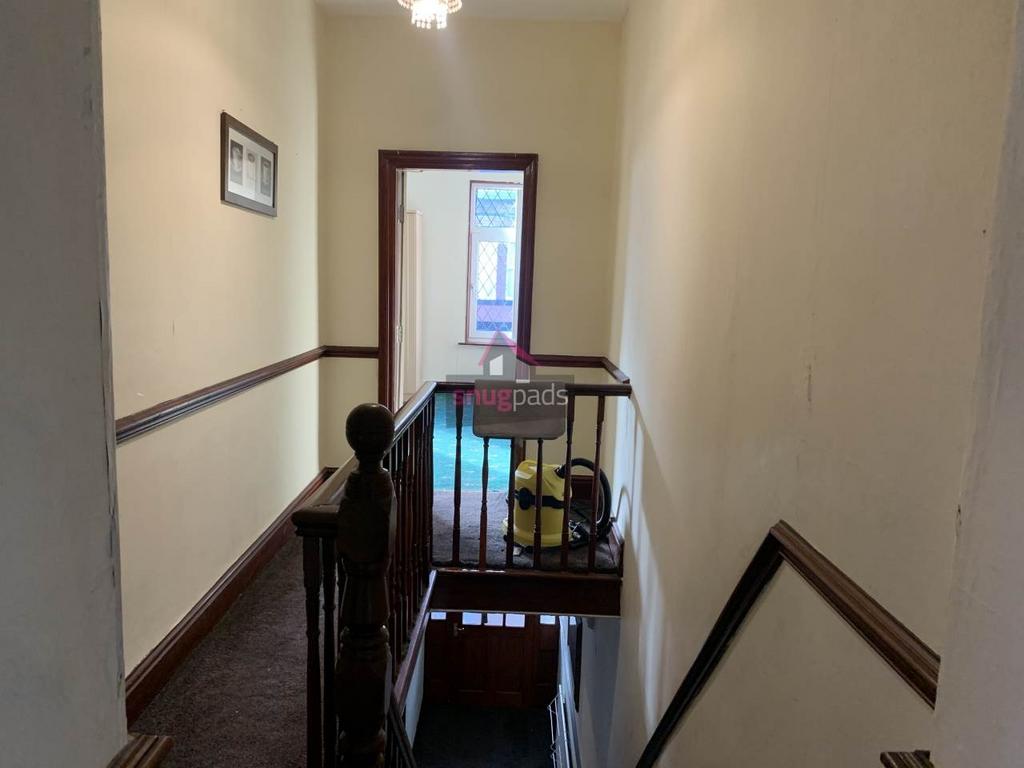 Bright upstairs landing and staircase with a wo...