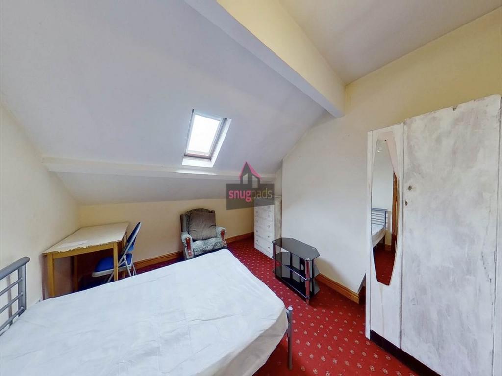 Bright attic double bedroom with a sloped ceili...