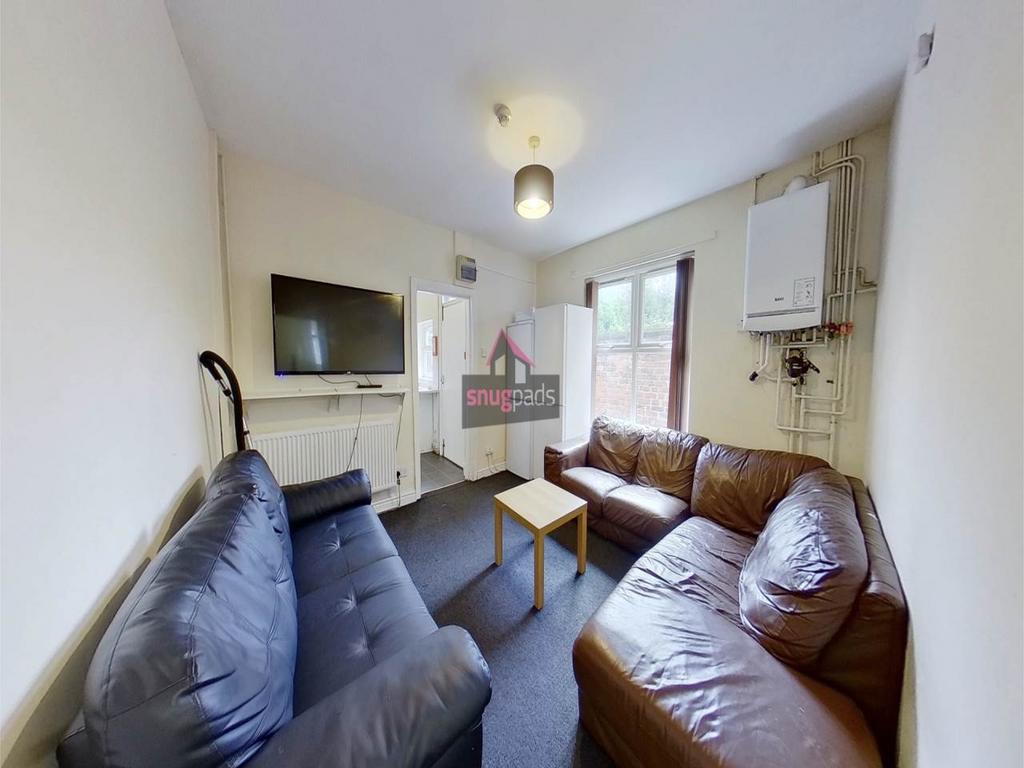 Bright communal living room with comfortable le...