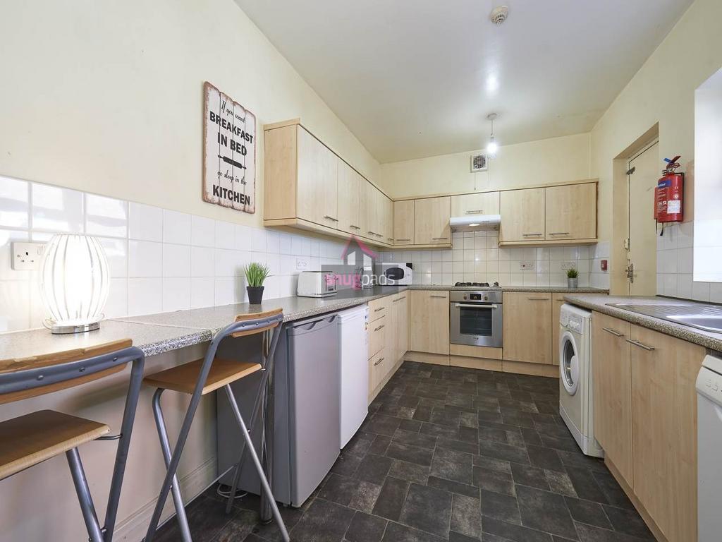 Bright, modern kitchen with light wood cabinetr...