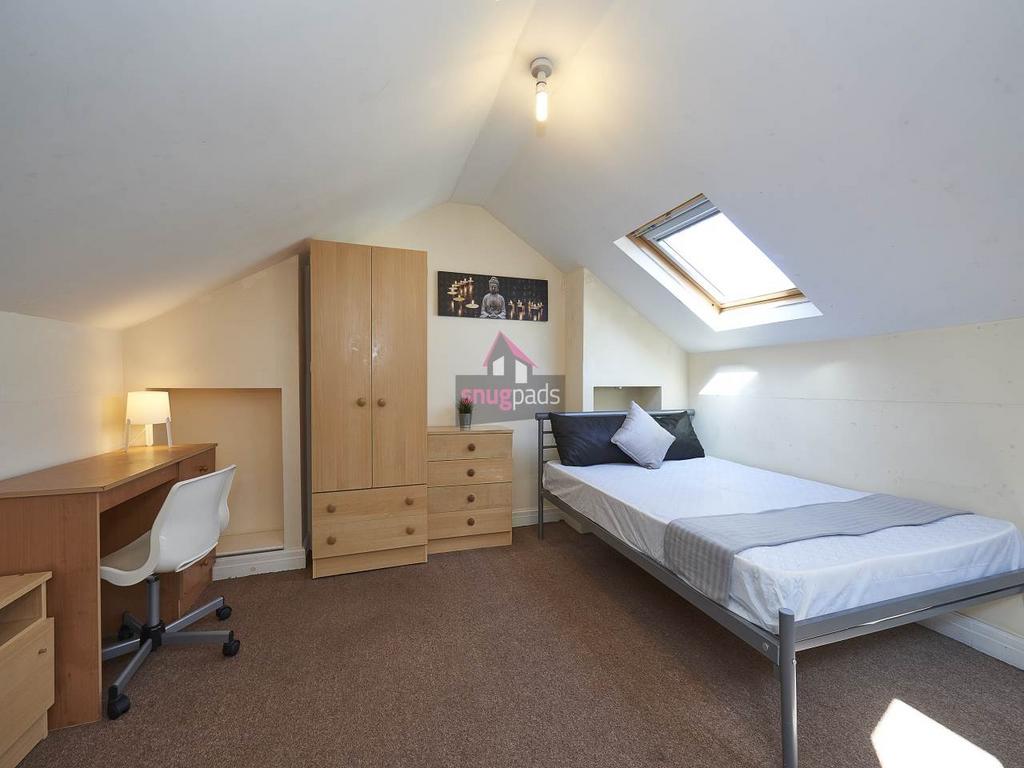 Bright, neatly furnished single bedroom with a ...
