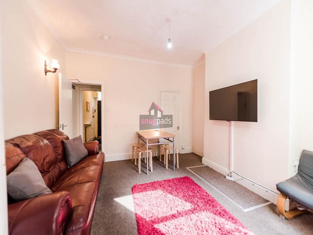 Bright communal living room with comfortable le...