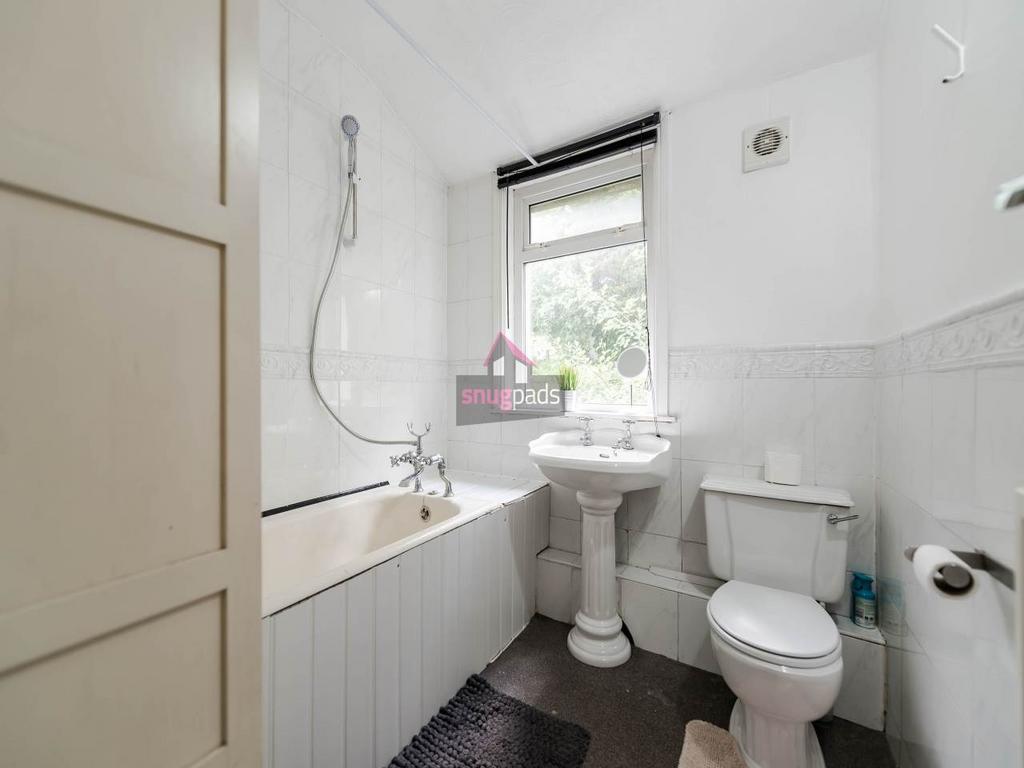 Bright, clean bathroom featuring a traditional ...