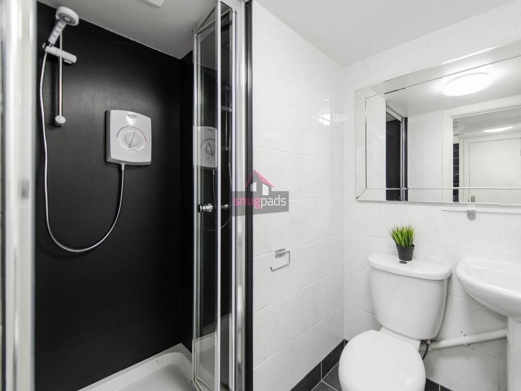 Modern bathroom with a frameless glass shower, ...