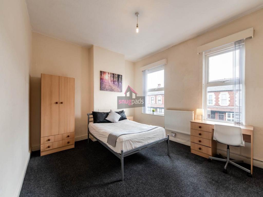 Bright double bedroom with large windows, simpl...