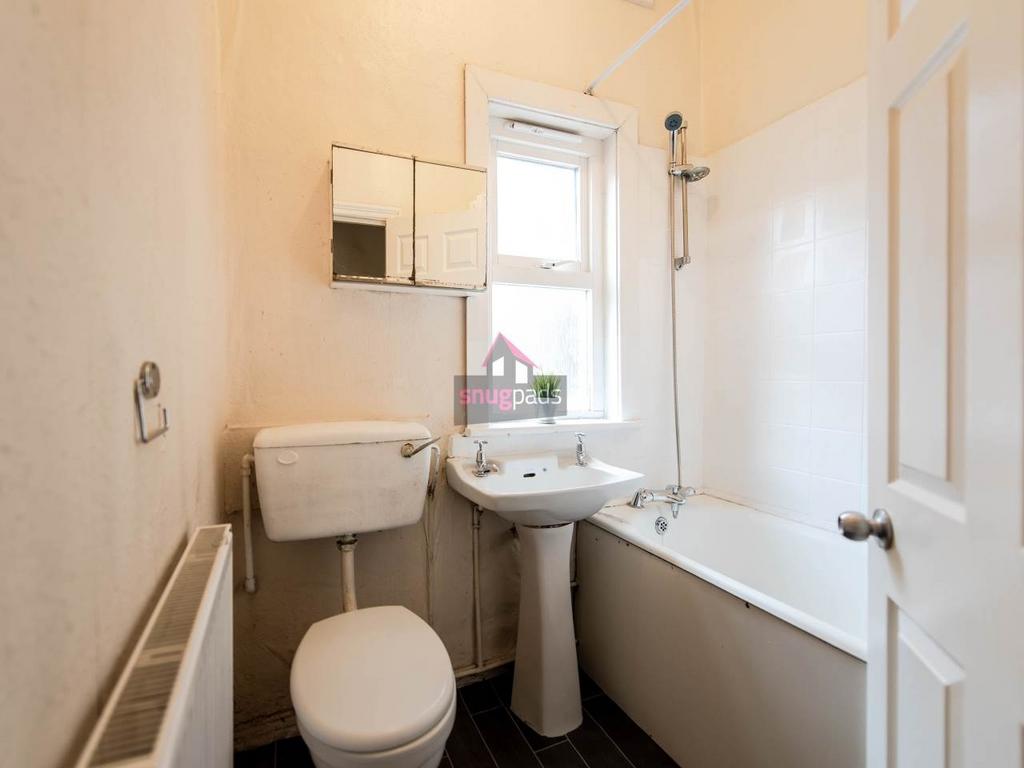 Well-maintained bathroom with a bathtub and ove...
