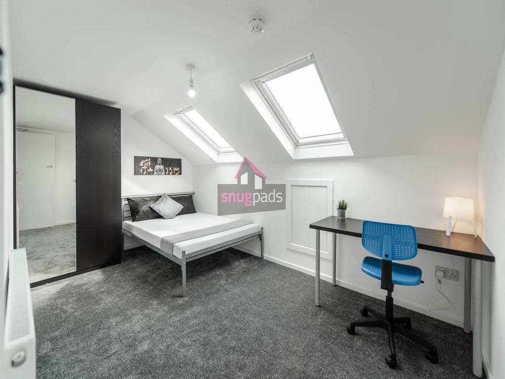 Bright, modern double bedroom with two skylight...