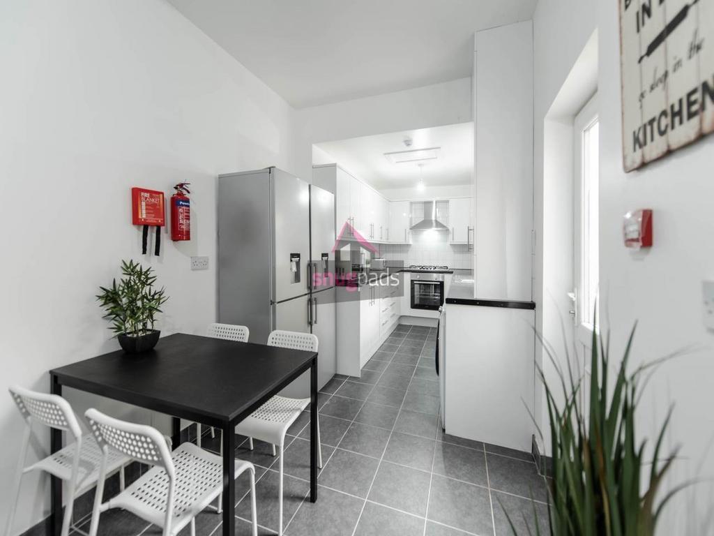 Modern galley kitchen with sleek white cabinets...