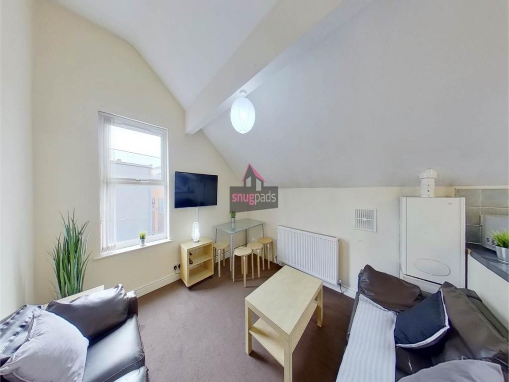 Bright, neatly furnished living room with vault...