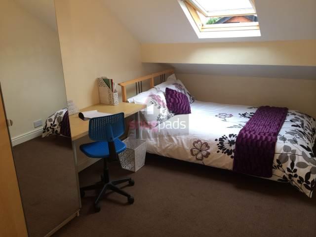 Bright attic double bedroom with a sloped ceili...