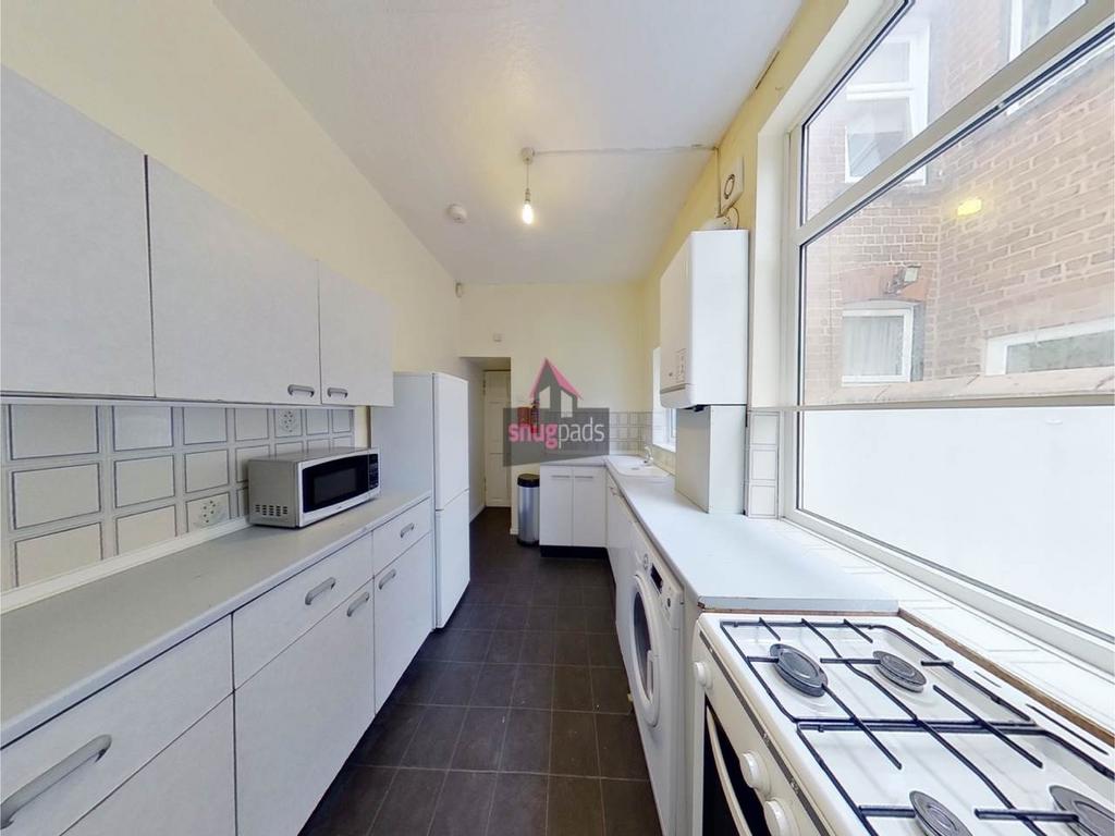 Bright galley kitchen with a long run of workto...