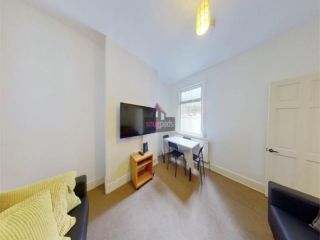 Bright, simply furnished living room with wall-...