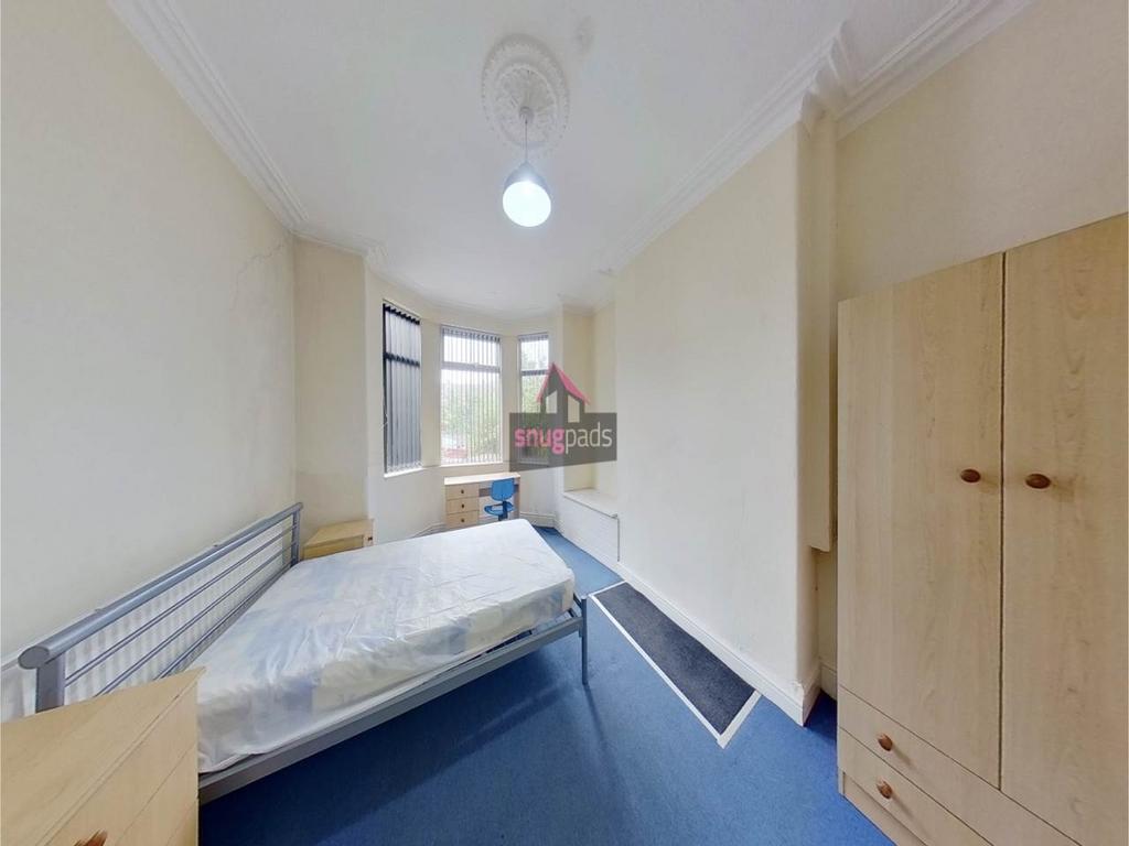 Bright bedroom with a large bay window, fitted ...