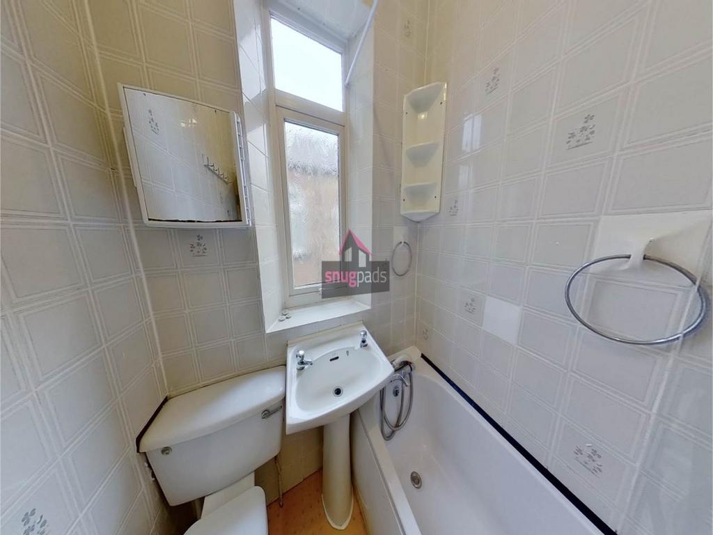 Well-maintained bathroom featuring a bathtub wi...