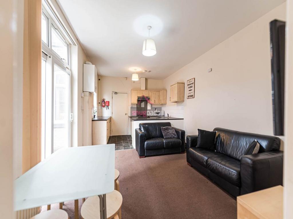 Bright open-plan living area with comfortable b...