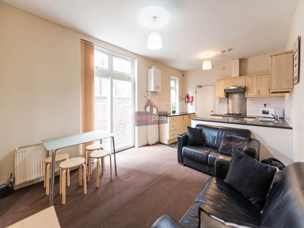 Bright open-plan living area with a kitchenette...