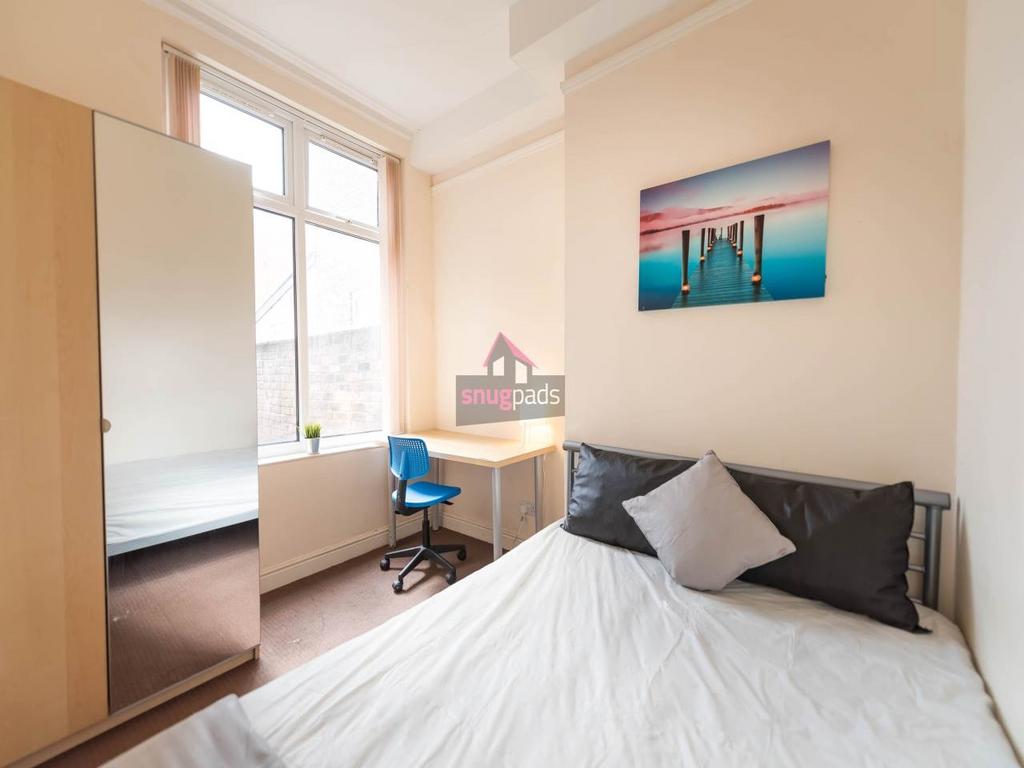 Bright, neatly presented bedroom with a large w...