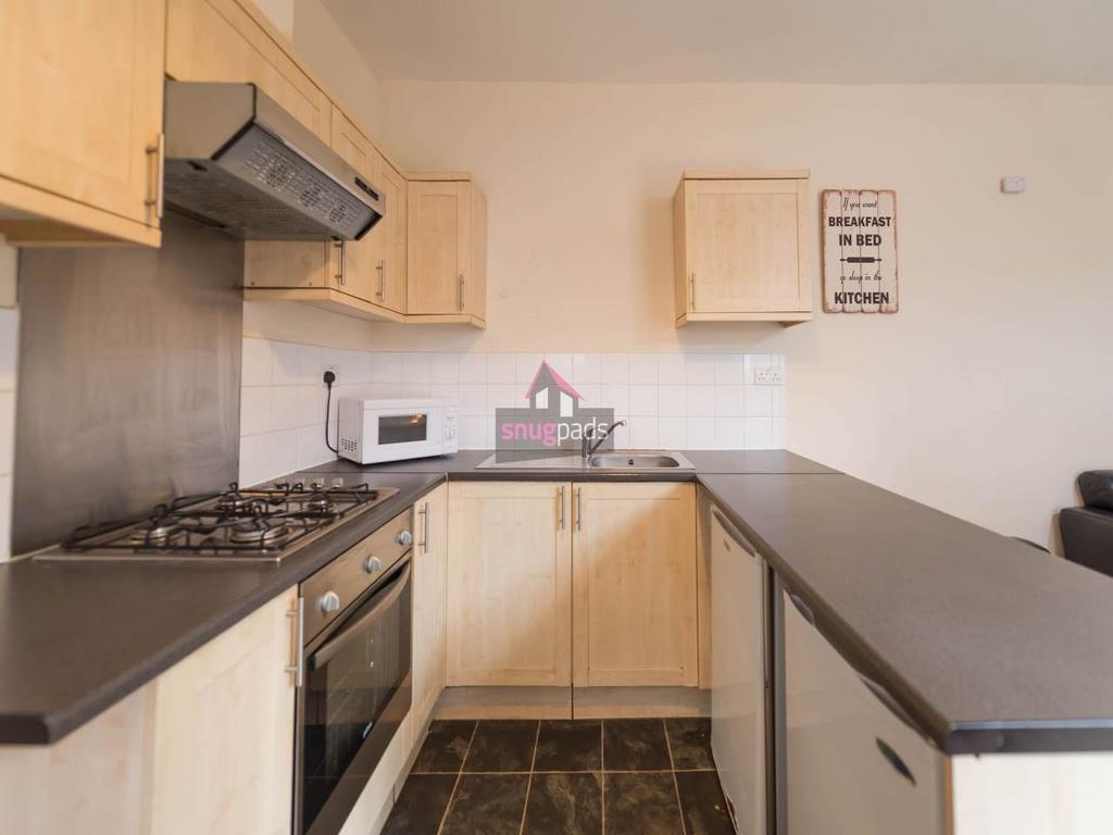 Bright modern kitchen with a gas hob, integrate...