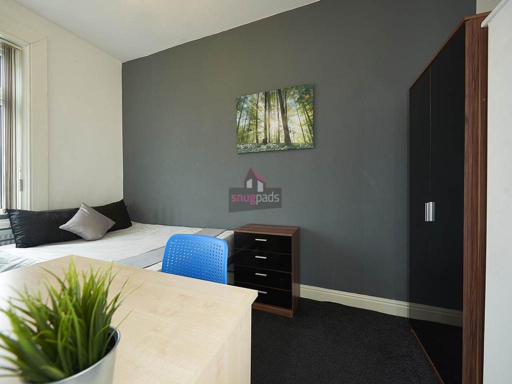 Bright, modern bedroom with a comfortable doubl...