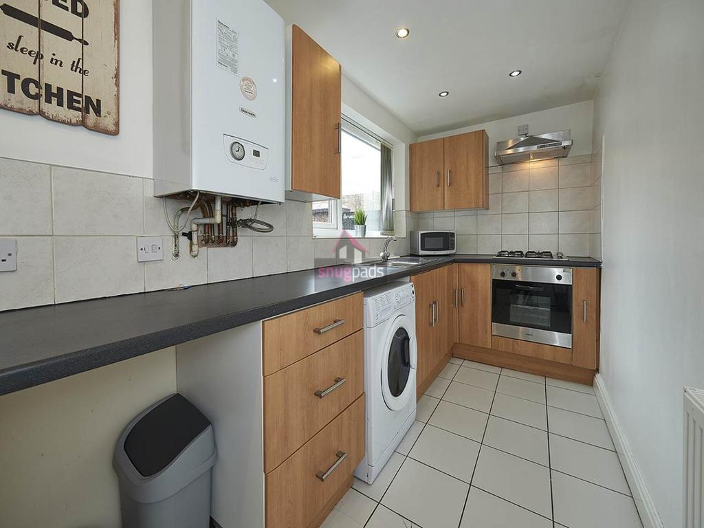 Bright, modern galley kitchen with wood-effect ...