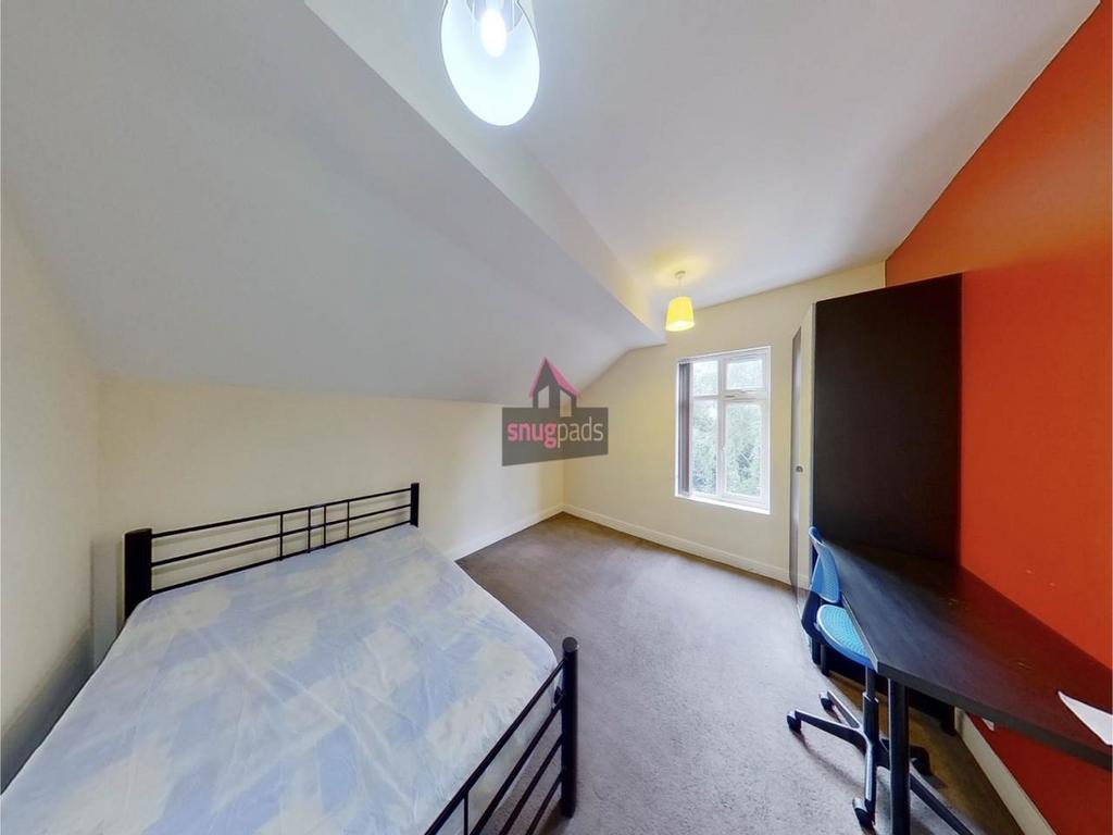 Bright double bedroom with a metal-frame bed, s...