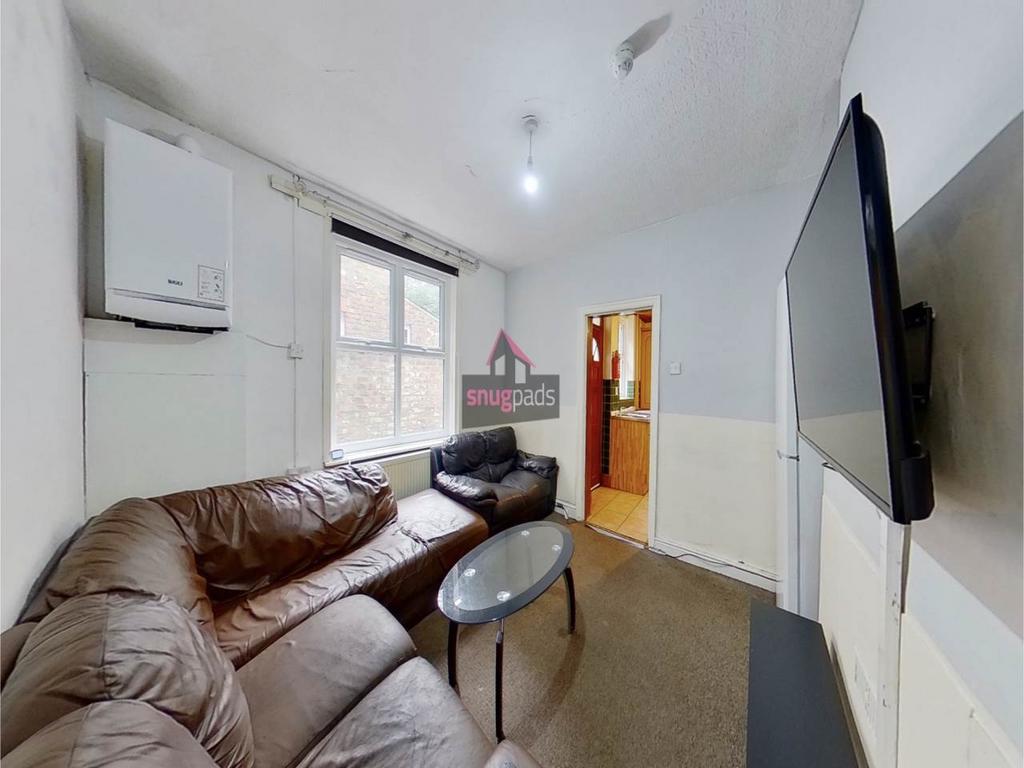 Cozy communal living room with a large L-shaped...