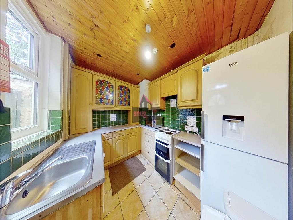 Warm, characterful kitchen with wood-panelled c...