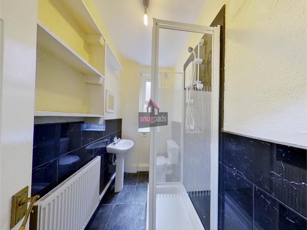 Bright, well-maintained bathroom with a glass-e...