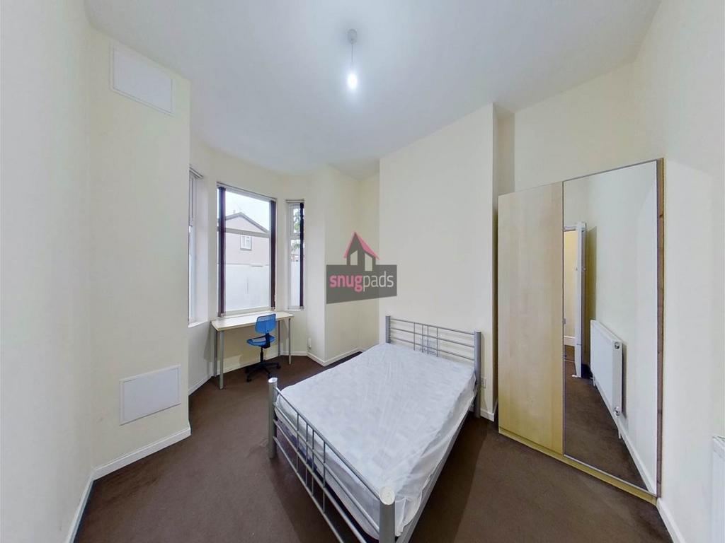 Bright, neat bedroom with a double bed, fitted ...