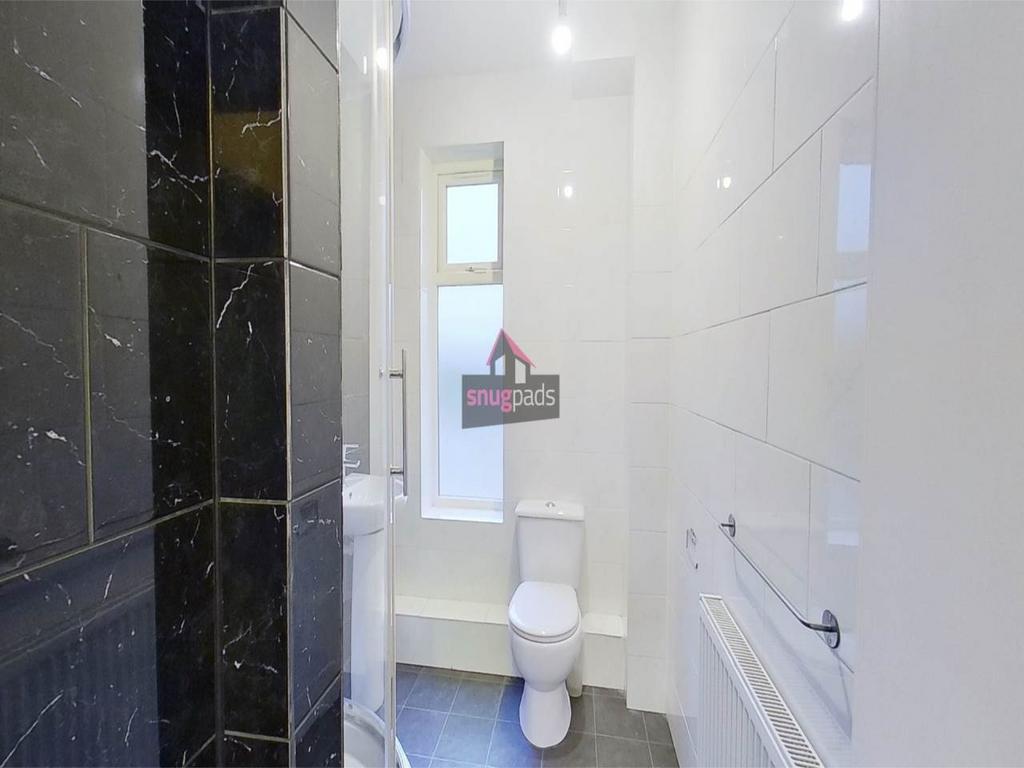 Bright, modern bathroom with glossy wall tiles,...